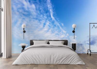 white fluffy clouds on a background of blue sky on a clear summer day Wall mural