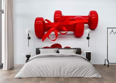 Two red dumbbells with a ribbon bow and two hearts on a white background. Concept of Valentines day, healthy lifestyle, giving gifts, love of sports. Wall mural