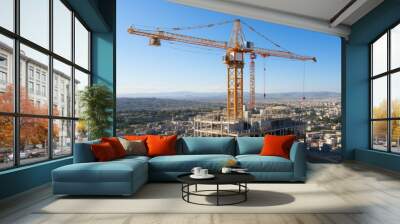 Construction site with towering cranes overlooking a city Wall mural