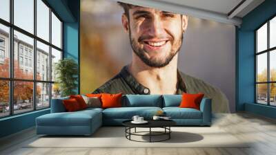 portrait of a young smiling man with dark hair and modern hair cut Wall mural