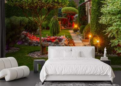 Garden illuminated by lamps in evening Wall mural