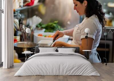 Pregnant chef preparing food in a professional kitchen Wall mural