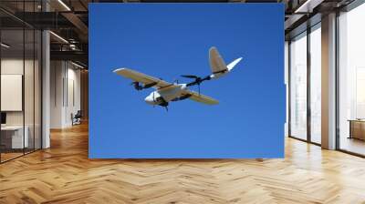 Hybrid drone flying in a cloudless day of blue sky Wall mural