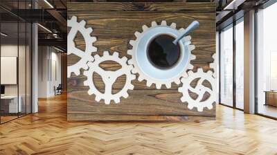 gear mechanism with a cup of coffee on a wooden background. Concept business idea, workflow, coffee break, teamwork, partnership Wall mural