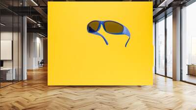 Color Children sunglasses isolated on yellow background. Concept of sun protection summer and vacation. Front view with copy space. Studio Shot Wall mural