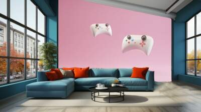 3d image of a couple gamepads on a beautiful pink pastel background Wall mural