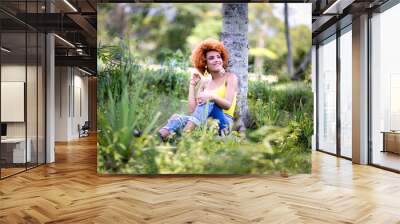 young woman in the park smiling Wall mural