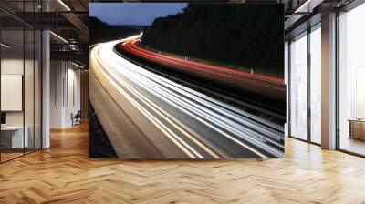 white and red traces of light from moving cars on highway at night six lines autobahn car road long exposure shot fast moving cars Wall mural