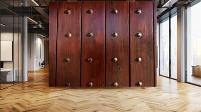 A solid wooden door close-up with rows of metal studs Wall mural