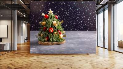 Christmas edible tree made from cheese, vegetables and sprigs of rosemary.  New Year food background, food art concept. Copy space. Wall mural