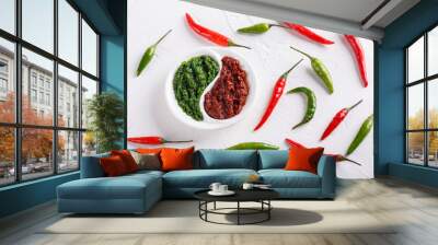 Hot chili pepper paste. Red and green sauce on white background. Adjika or ajika in Georgian cuisine or harissa in Arabic cuisine. Top view. Wall mural