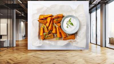 Sweet potato wedges. Oven baked sweet potato with herbs served with  white sauce on gray background. Healthy vegetarian food concept. Top view. Wall mural