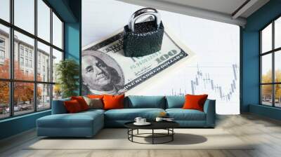 Lock on a pack of dollars on a white background with chart. Wall mural