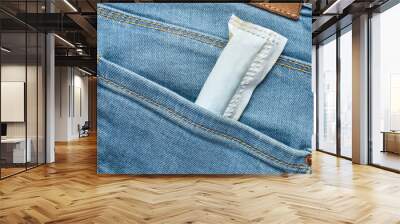 Tampon in a bag in a back pocket of jeans. Wall mural