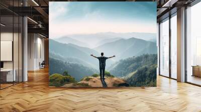 Back view man standing on the cliff enjoying beautiful view on mountain Wall mural