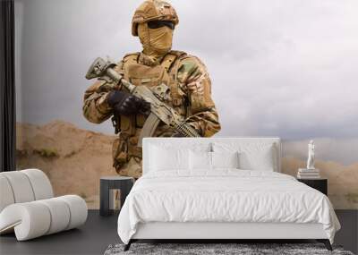 Armed special forces soldier in camouflage holding rifle close-up Wall mural