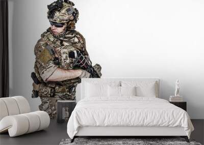 Elite member of US Army rangers in combat uniforms with his shirt sleeves rolled up, in helmet, eyewear and night vision goggles, in turning around in action. Studio shot, white background Wall mural