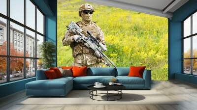 Equipped and armed special forces soldier in the blooming field with copy space for text Wall mural