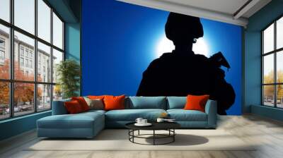 Silhouette of army infantry soldier armed assault rifle on background of night sky with moon. Special operations forces fighter in combat helmet and uniform during night mission, military sentry duty Wall mural