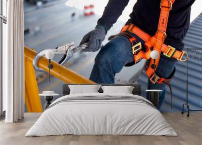 construction worker use safety harness and safety line working on a new construction site project. Wall mural