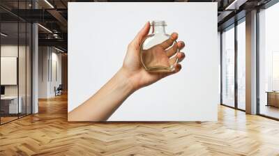 Hand of person holding glass bottle with white background Wall mural