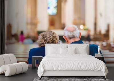 Back view of an elderly couple in the church, Madrid, Spain. Copy space for text. Wall mural