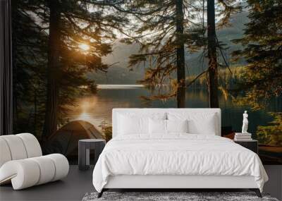 A scenic campsite with a tent, campfire, and two chairs overlooking a tranquil lake at sunset. Wall mural