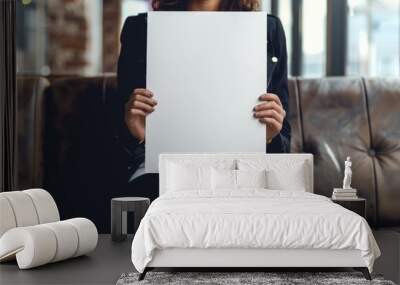 Female hands holding blank white paper sheet. Wall mural