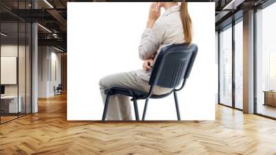 back view of young beautiful  woman sitting on chair.  girl  watching. Rear view people collection.  backside view of person.  Isolated over white background. Girl with long hair in a white jacket is Wall mural