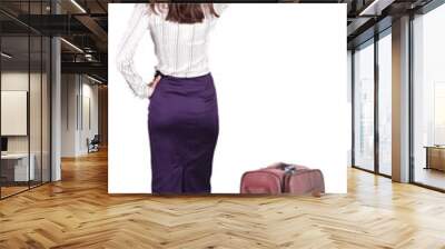 Back view of young brunette woman traveling with suitcas and poi Wall mural