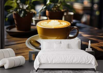 Coffee in yellow cup on wooden table in cafe Wall mural