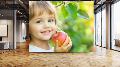 Happy Child Holding an Apple in Orchard Wall mural