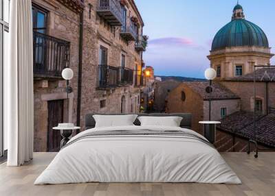 Tiny old village of Gangi, in Sicily, at sunset, with houses made of stone bricks, is a tipical example of sicilian farmer’s village. The church on the right has a blue metal dome. Wall mural