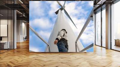 Girl looks at wind turbine Wall mural