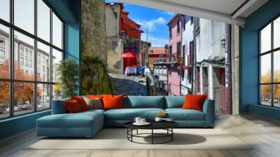 Facade of colorful buildings among the streets of the old city in Porto, Portugal. Wall mural