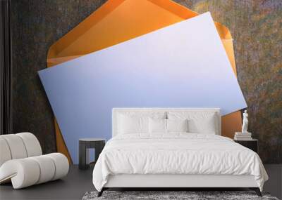 An orange envelope with a white piece of paper on it Wall mural