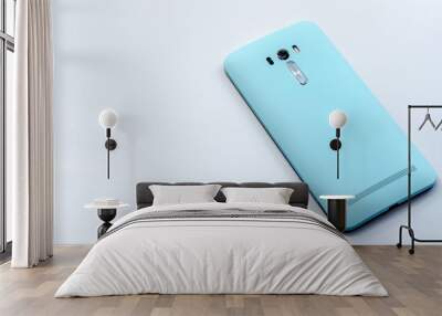 Blue smart phone on the background Wall mural