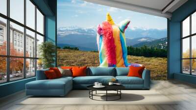 Feel freedom concept in mountains, woman traveling in a unicorn costume Wall mural