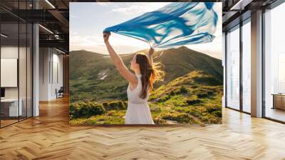 Woman feel freedom and enjoying the nature Wall mural