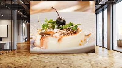 Muhallebi, a traditional milk pudding dessert, originally from Turkey,  made of milk and cornflower, served in a white plate with almonds, sugar powder and a cherry Wall mural