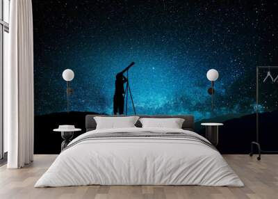 Silhouette of little child looking through a telescope Wall mural