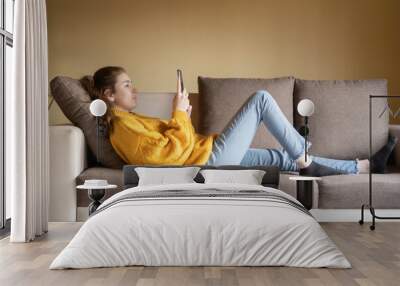 young woman resting on her sofa Wall mural