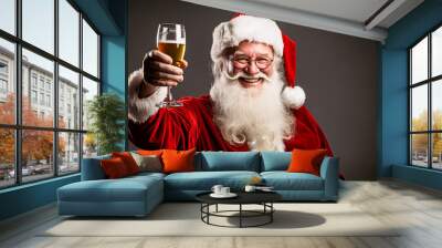 Smiling ruddy Santa Claus drinking a glass of beer Wall mural