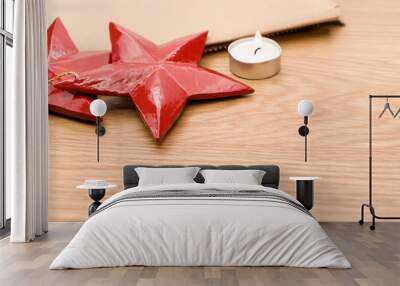 red wooden stars Christmas decoration and tea light on a wooden background Wall mural