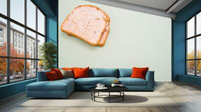 Slices of bread isolated on smooth gray background Wall mural