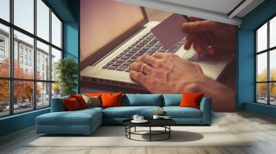 Man typing on a laptop keyboard Wall mural