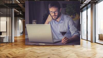 Man working on a laptop at night Wall mural