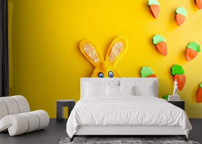 Easter decoration, easter bunny and carrots on yellow background. Wall mural