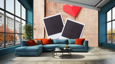 Instant photos with origami hearts. On wooden background Wall mural