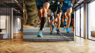 A close-up view of runners' legs as they compete in a marathon race, highlighting their speed and determination. The image captures the dynamic motion and athleticism of the participants. Wall mural